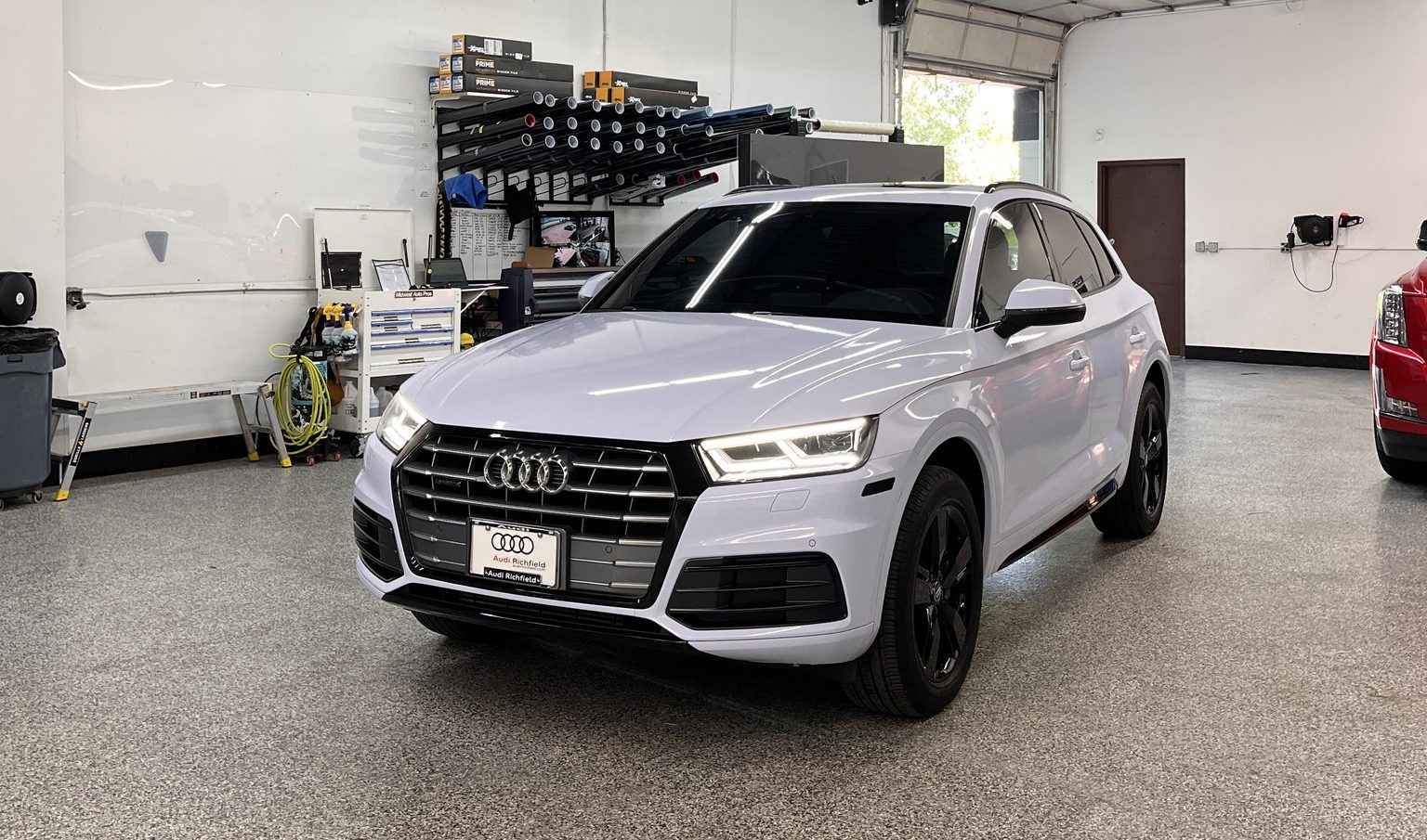 A white Audi Q5 in the Midwest Auto Pros install bay in Chanhassen, Minnesota